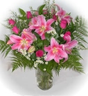 Pink roses and lilies in a glass vase